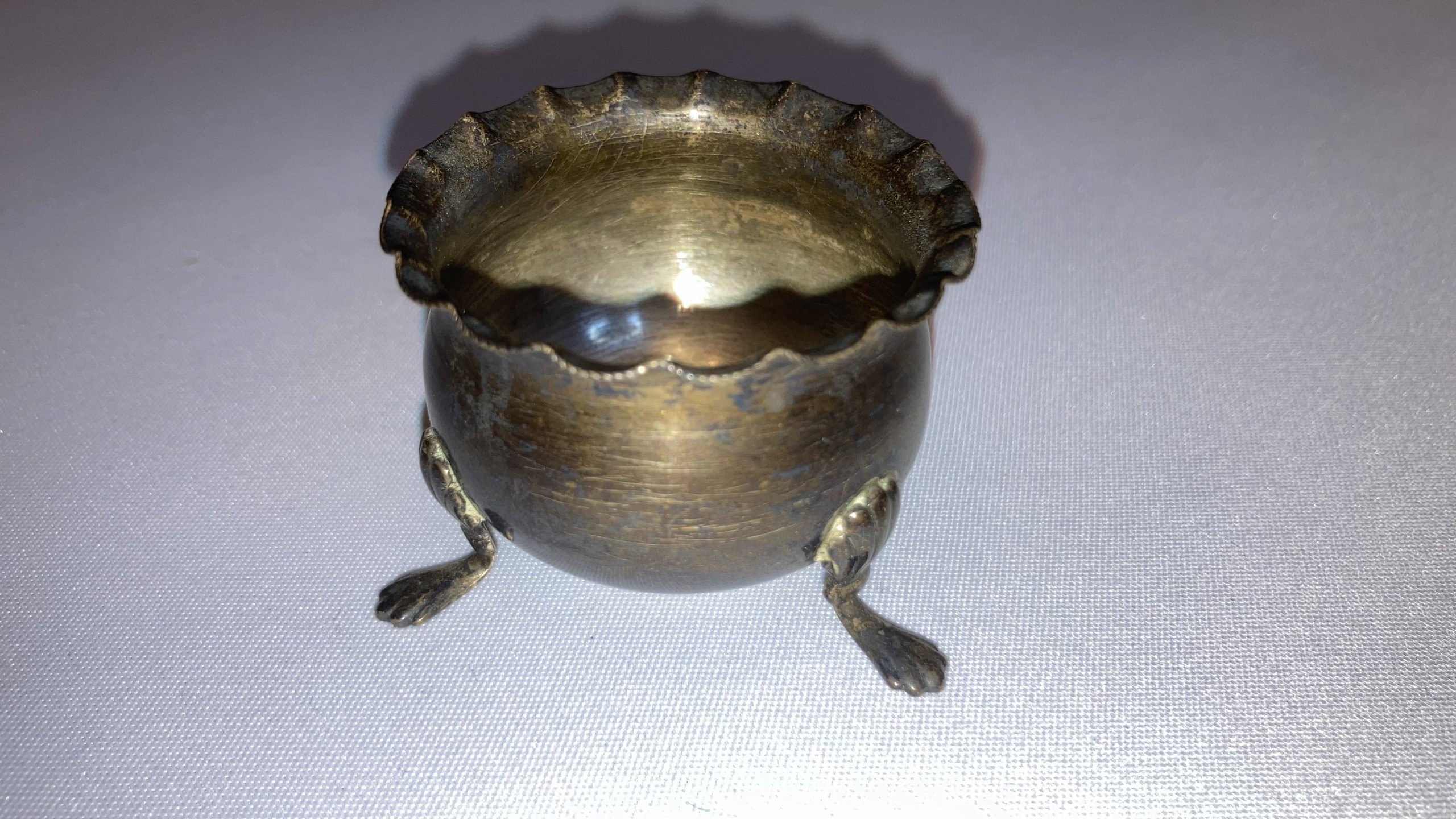 Adam's tat (possibly treasure) - a tiny cauldron he got for 10p