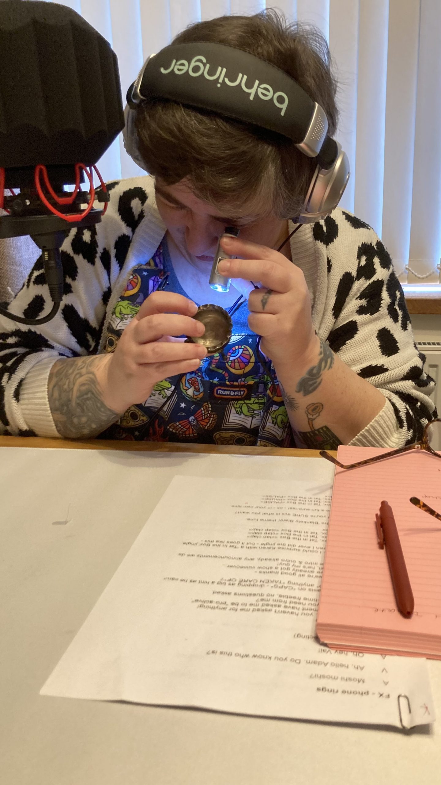 Karen tries to examine the tiny sterling silver cauldron through the microscope