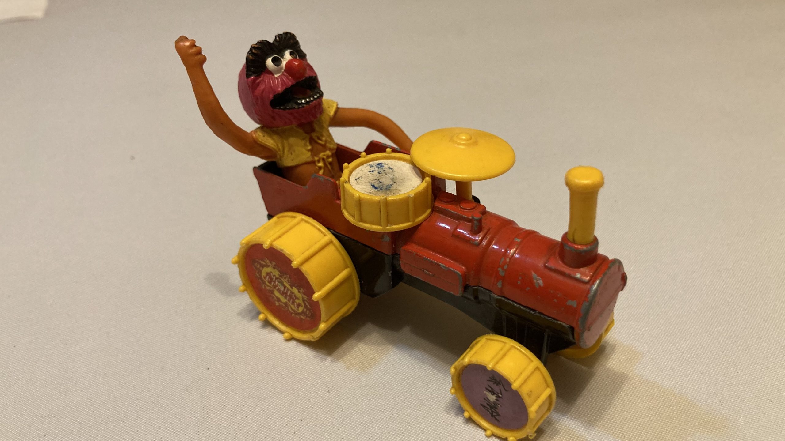 Adam's tat - a Corgi toy of Animal from The Muppet Show on a drum tractor