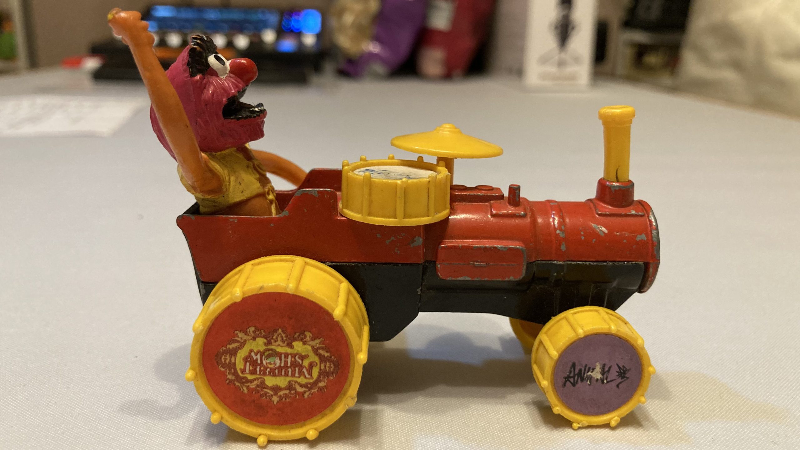 Adam's tat - a Corgi toy of Animal from The Muppet Show on a drum tractor