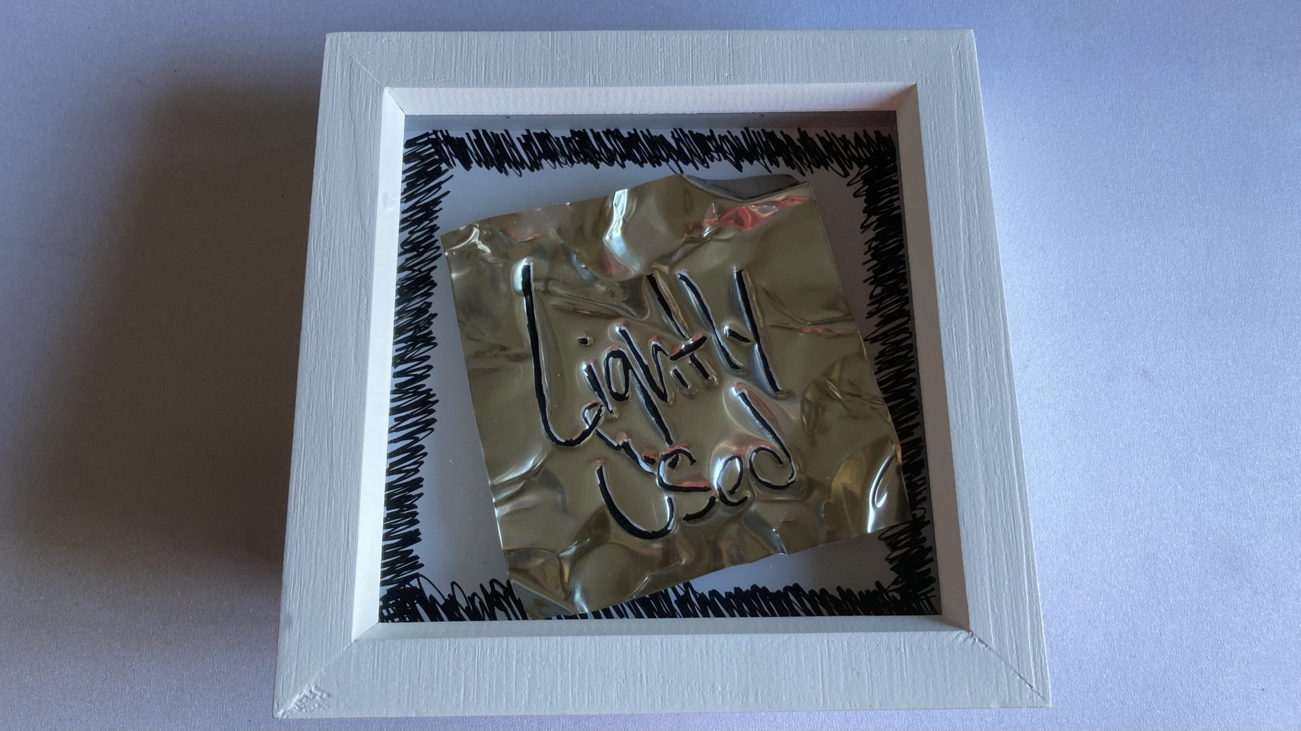 Adam caused the plaque Karen made for last episode to go wonky when he tried to put it on a scanner for a picture.